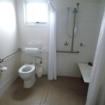 Jervis Bay Holiday Cabins shower with seat and rails. Toilet with side rail