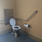 accessible toilet with rear and side rails